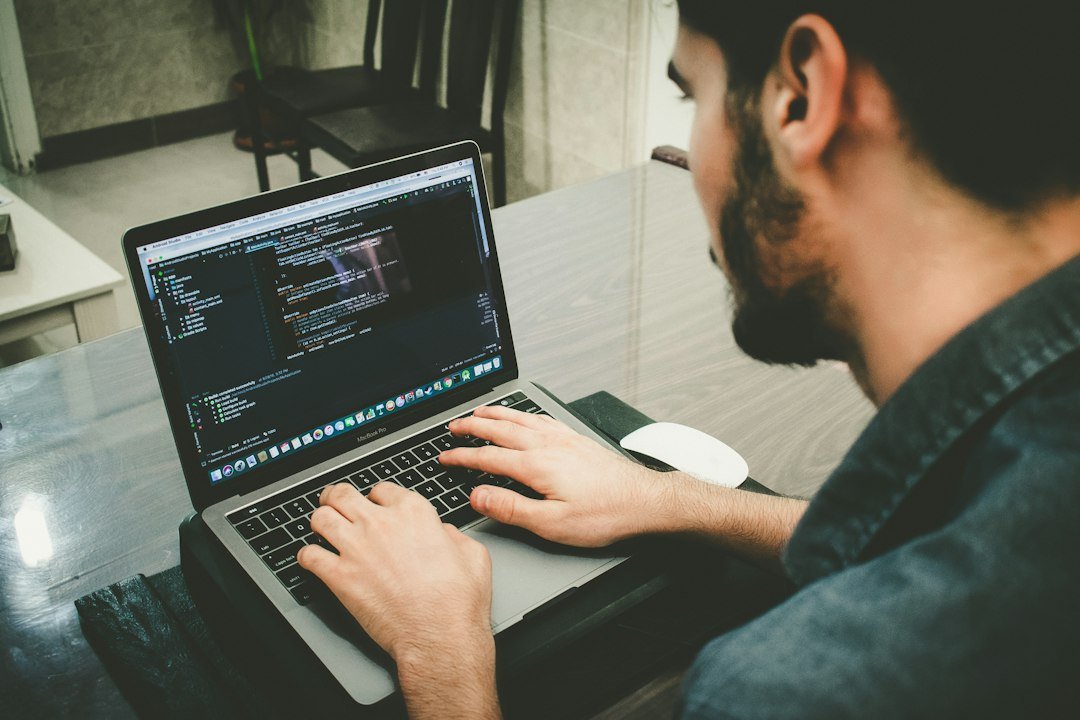 Developer using an AI coding assistant on a laptop